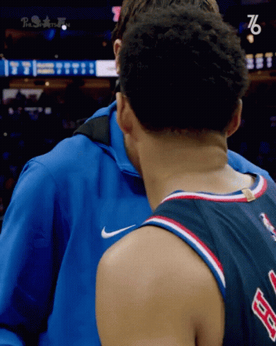 Man In Blue Jacket Hugging 76 Jersey GIF