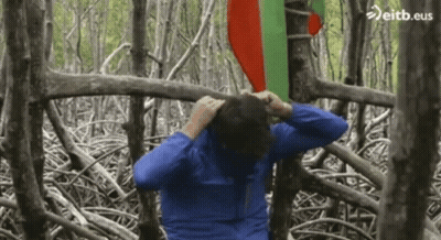 Man In Blue Jacket In Forest With Eitb.eus GIF