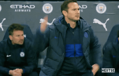 Man In Blue Jacket In Front Of Etihad Airways Banner GIF