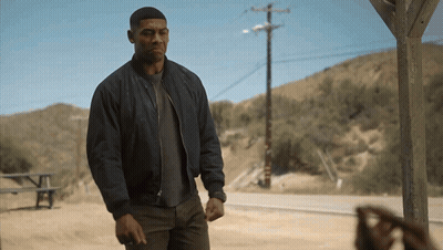 Man In Blue Jacket In Front Of Mountain GIF
