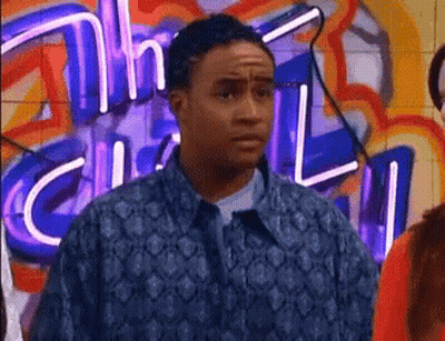 Man In Blue Jacket In Front Of Neon Sign Saying Chill GIF