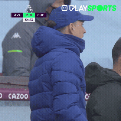 Man In Blue Jacket In Front Of Scoreboard GIF