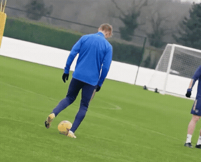 Man In Blue Jacket Kicking Soccer Ball GIF
