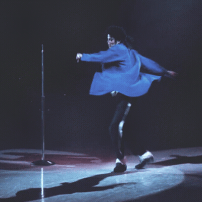 Man In Blue Jacket Kneeling At Microphone GIF