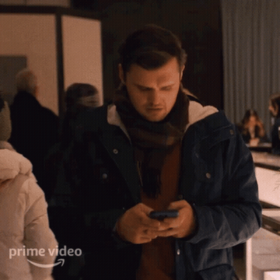 Man In Blue Jacket Looking At Phone Prime Video GIF