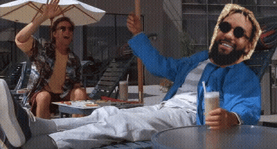 Man In Blue Jacket Lying On Lawn Chair Legs Crossed GIF