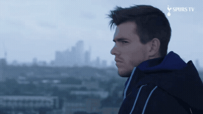 Man In Blue Jacket Overlooking City With Spurs TV GIF