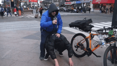 Man In Blue Jacket Pushes Leashed Man Next To Bike GIF