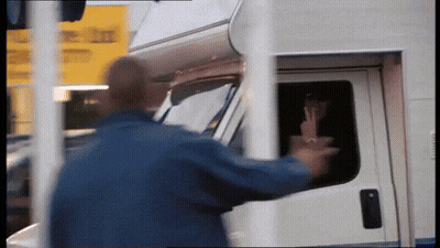 Man In Blue Jacket Reaching Into White Van GIF