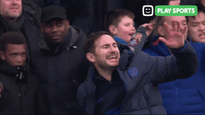 Man In Blue Jacket Screaming In Front Of Crowd With Play Sports Sign GIF