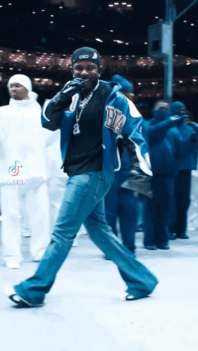 Man In Blue Jacket Singing Into Microphone GIF