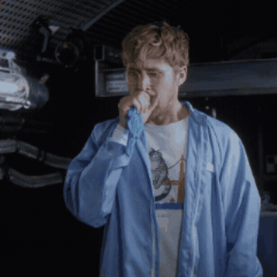 Man In Blue Jacket Singing Into Microphone With Space Shirt GIF