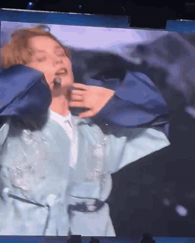 Man In Blue Jacket Singing Into Microphone GIF