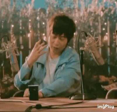 Man In Blue Jacket Sitting At Table GIF