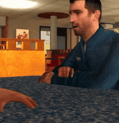 Man In Blue Jacket Sitting At Table With Another Man GIF