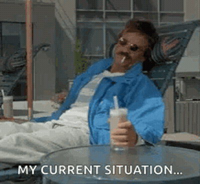 Man In Blue Jacket Sitting Holding Drink And Cigarette GIF