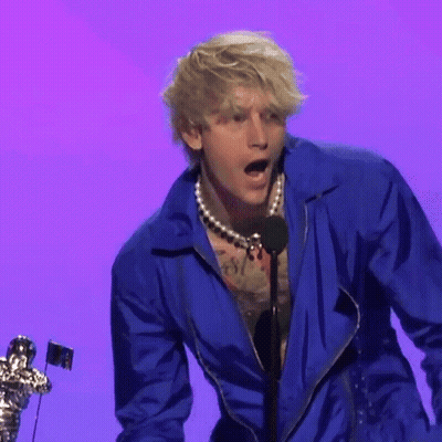 Man In Blue Jacket Speaking Into Microphone On Stage GIF