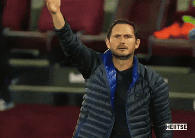 Man In Blue Jacket Standing By Heitse Sign GIF