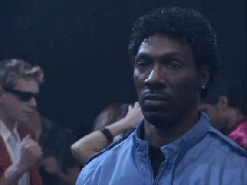 Man In Blue Jacket Standing In Dark Room GIF