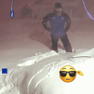 Man In Blue Jacket Standing In Snow Beside Smiley With Sunglasses GIF