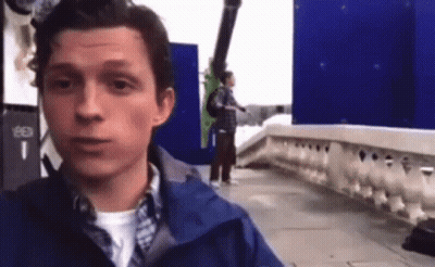 Man In Blue Jacket Standing On Sidewalk GIF