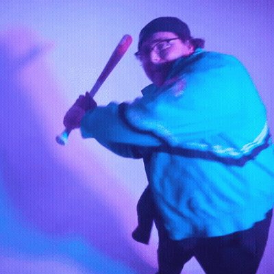 Man In Blue Jacket Swinging Bat GIF