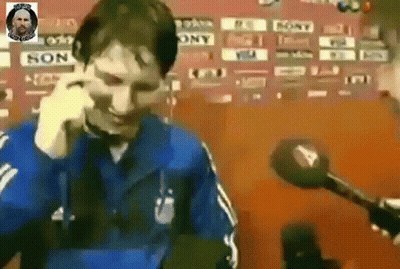 Man In Blue Jacket Talking On Cell Phone With Microphone GIF
