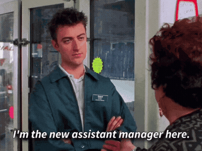 Man In Blue Jacket Talking To New Assistant Manager GIF