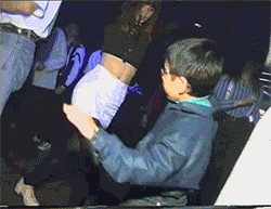 Man In Blue Jacket Touching Woman's Butt In Club GIF