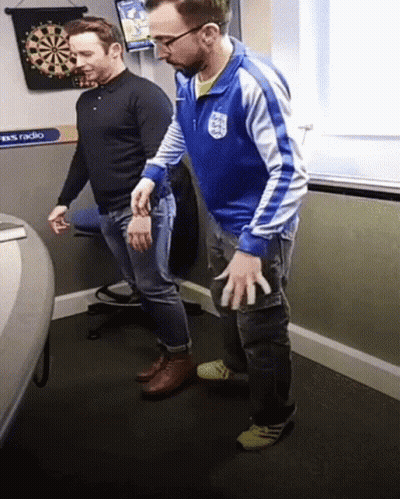 Man In Blue Jacket With England Next To Another Man GIF