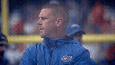 Man In Blue Jacket With Gator Logo GIF