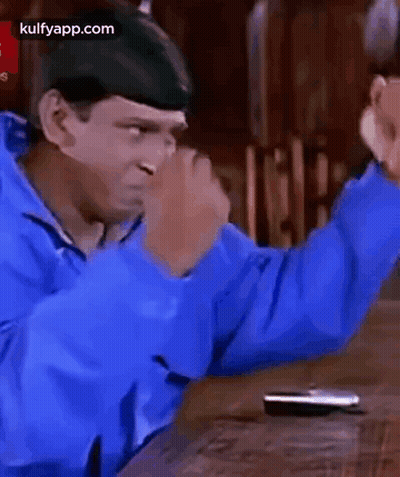 Man In Blue Jacket With Hands In The Air GIF