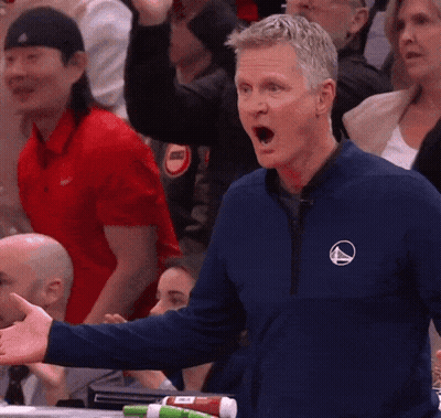 Man In Blue Jacket With Triangle Logo GIF