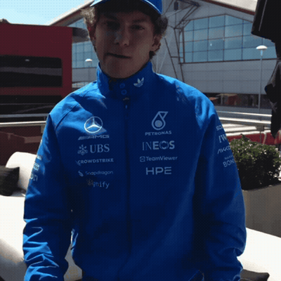 Man In Blue Jacket With UBS And INEOS Sponsors GIF