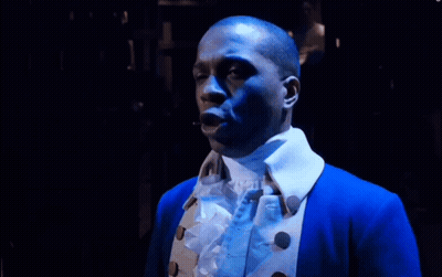 Man In Blue Jacket With White Collar Looking Down GIF