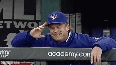 Man In Blue Jays Hat Leaning Over Fence GIF