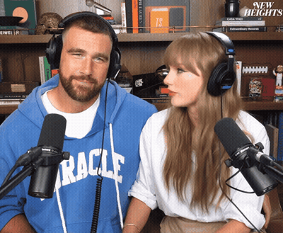 Man In Blue Miracle Sweatshirt Beside Woman In White Shirt GIF