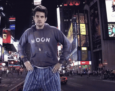 Man In Blue Moon Sweatshirt On City Street GIF