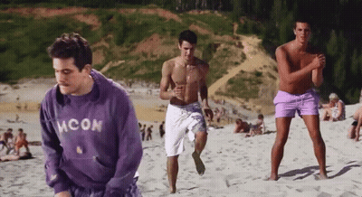 Man In Blue Moon Sweatshirt On City Street At Night GIF