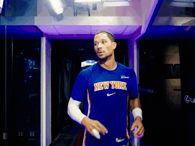 Man In Blue New York Shirt Walking Through Purple Doorway GIF