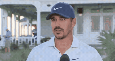 Man In Blue Nike Hat And White Shirt Talking Into Microphone GIF