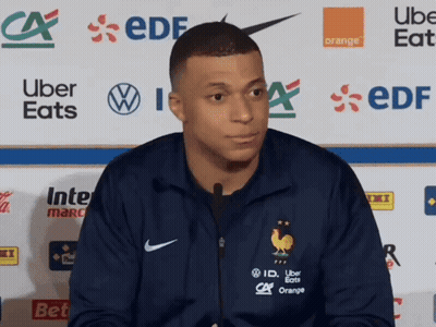 Man In Blue Nike Jacket In Front Of Uber Eats And EDF Logos GIF