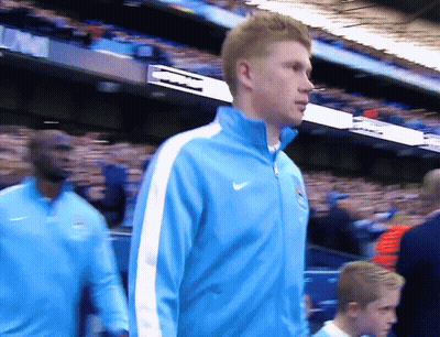 Man In Blue Nike Jacket Walking In Crowd GIF