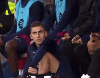 Man In Blue Nike Vest Sitting In Stadium GIF