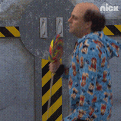Man In Blue Onesie Holding Lollipop GIF