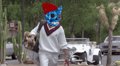 Man In Blue Pirate Mask Walking Past Stop Sign GIF