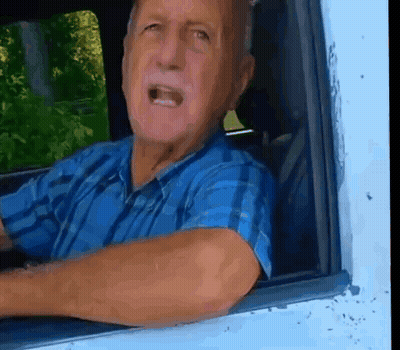Man In Blue Plaid Shirt Looking Out Car Window GIF