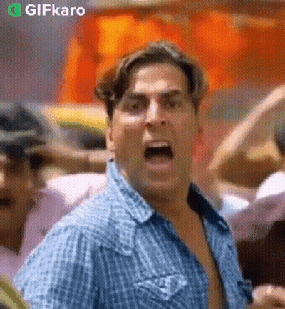 Man In Blue Plaid Shirt Screaming In Crowd GIF