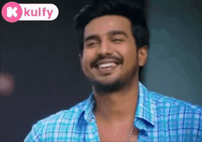 Man In Blue Plaid Shirt Smiling With Kolfy Logo GIF