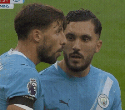 Man In Blue Puma Shirt Talking To Another Man GIF